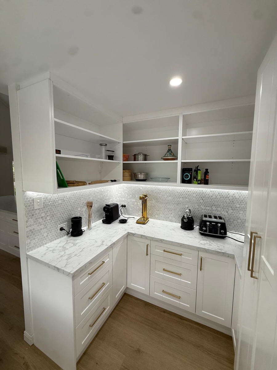 White butler's pantry with open shelving, marble benchtop and mosaic splashback, built by Quality Cabinets